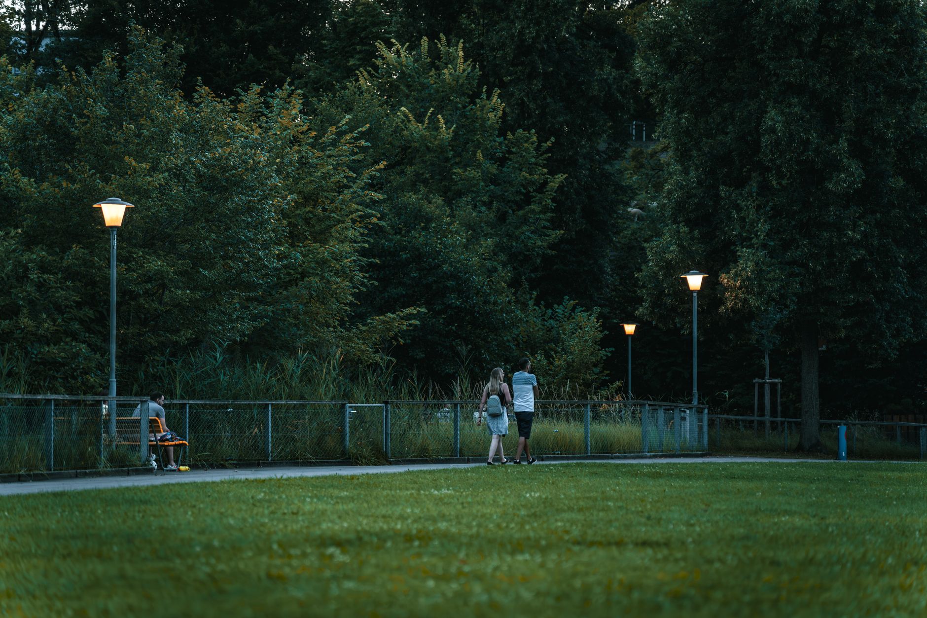Audience watching an open air cinema UK 2026 screening in a park at dusk