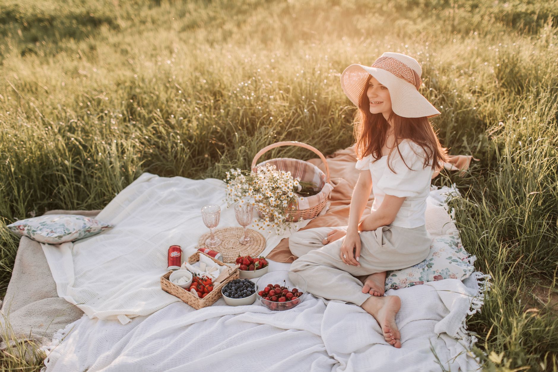 Family enjoying outdoor picnic spots UK on a summer meadow with rolling countryside behind them