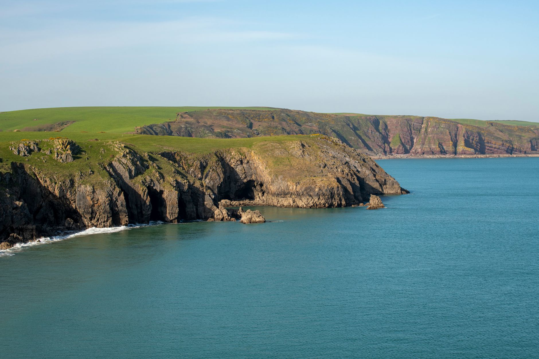 Walkers on the Pembrokeshire Coast Path near hidden coastal villages Wales