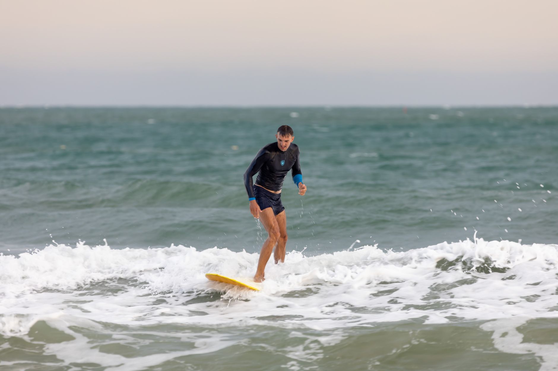Beginner surf lesson on a sandy UK beach — uk surf schools beginners 2026