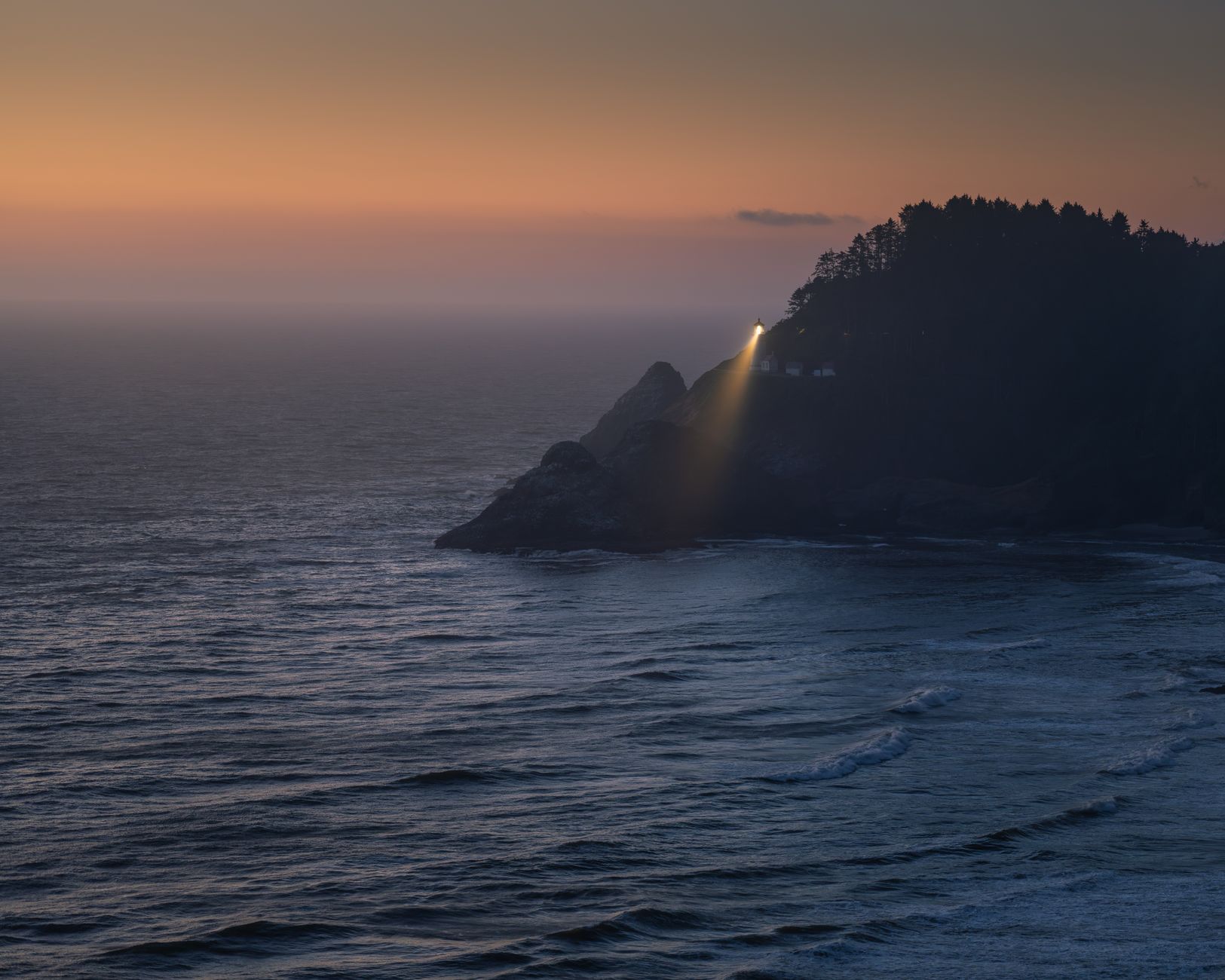 Converted lighthouse on coastal cliffs at sunset, ideal for lighthouse stays UK